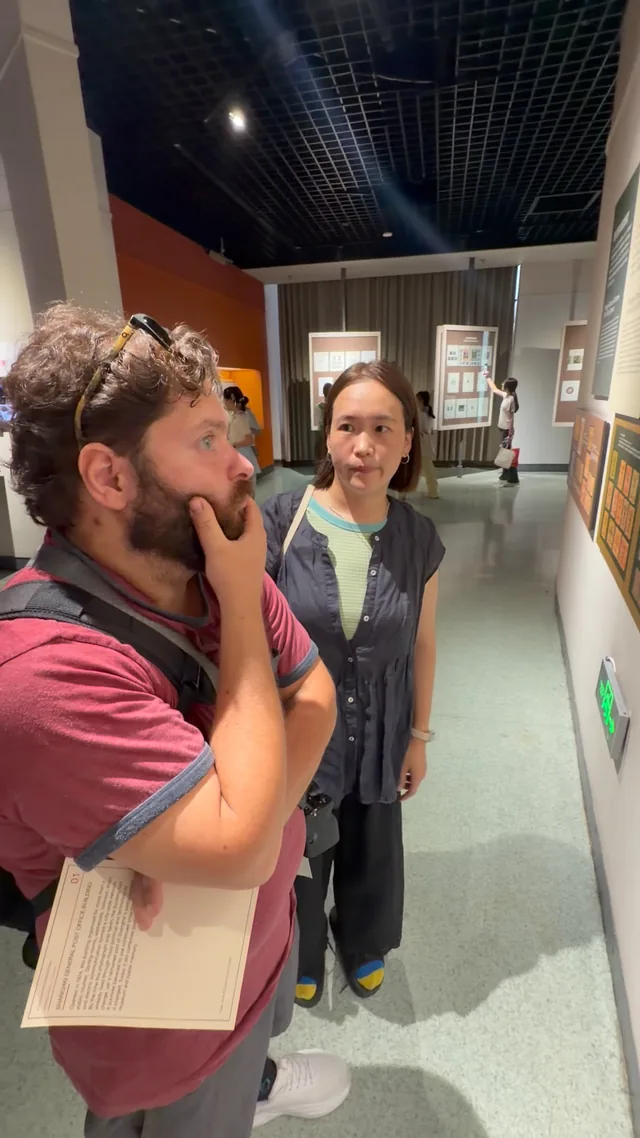 A Buddy and guest looking at an exhibit together.