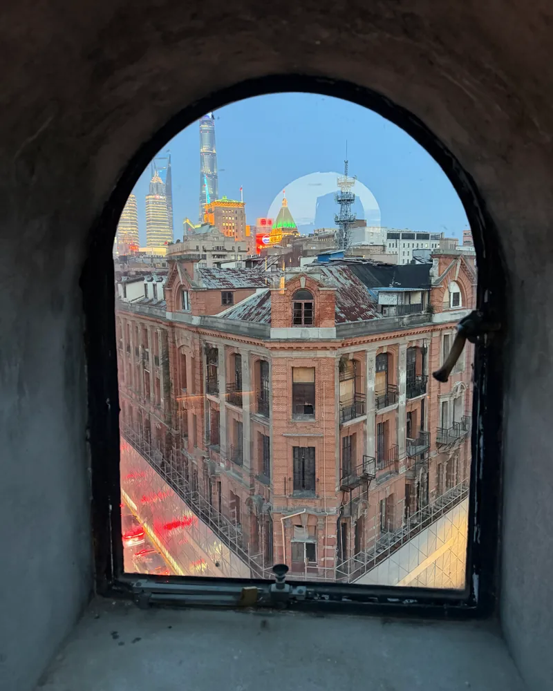 Shanghai architecture seen through a complete arched window opening